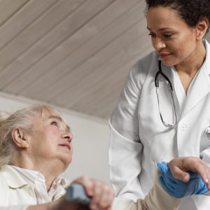 doctor-helping-her-old-patient-stand-up